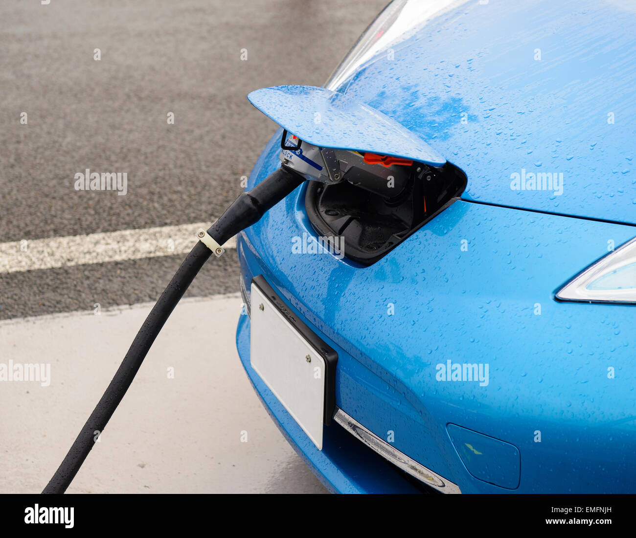 Electric car in charging Stock Photo
