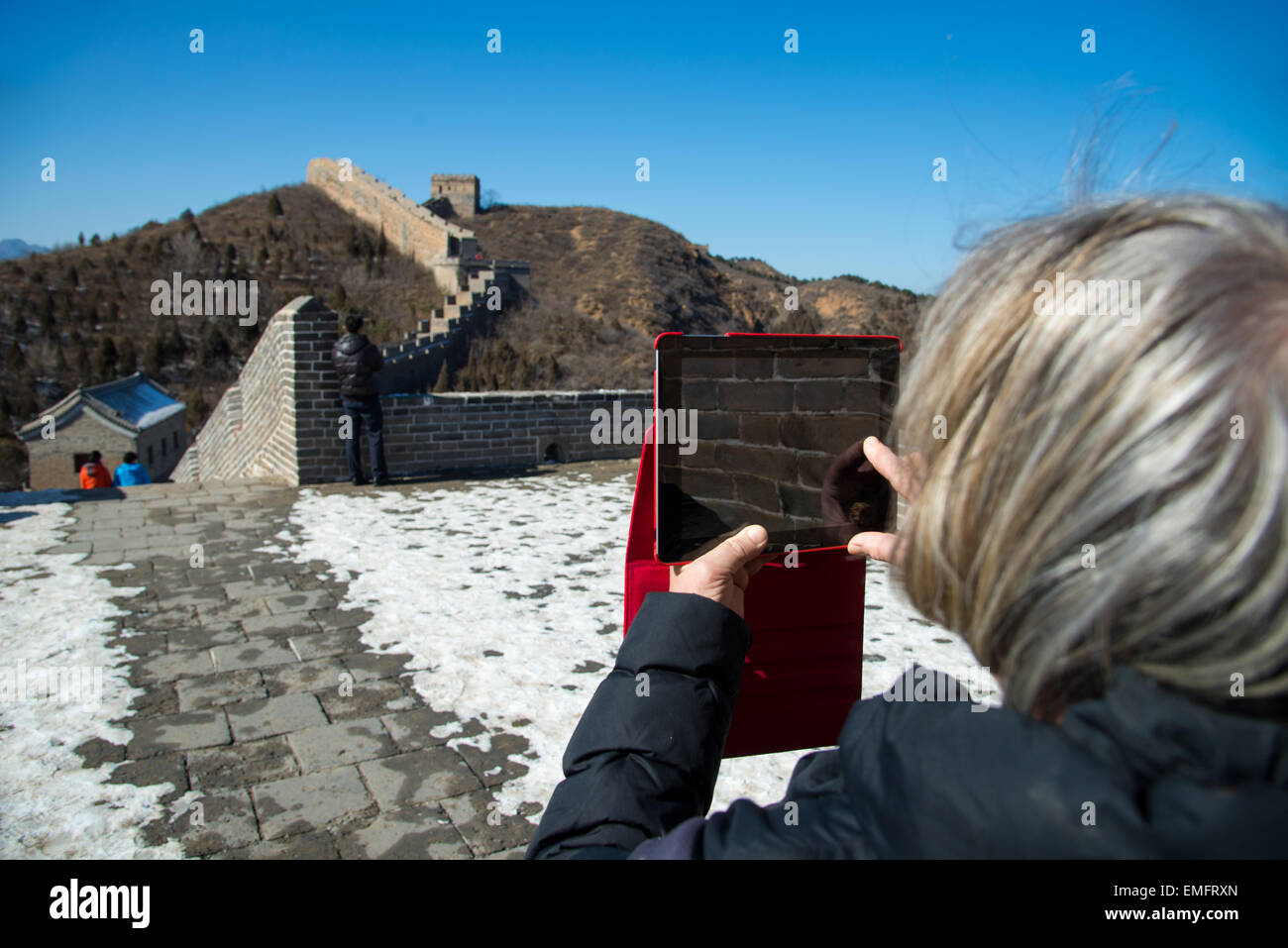 tourist takes photo with ipad at famous chinese wall at jinshaling Stock Photo