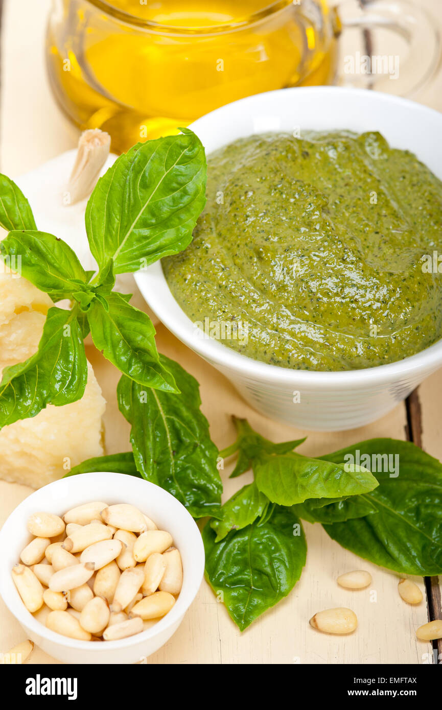 Italian traditional basil pesto sauce ingredients on a rustic table Stock Photo