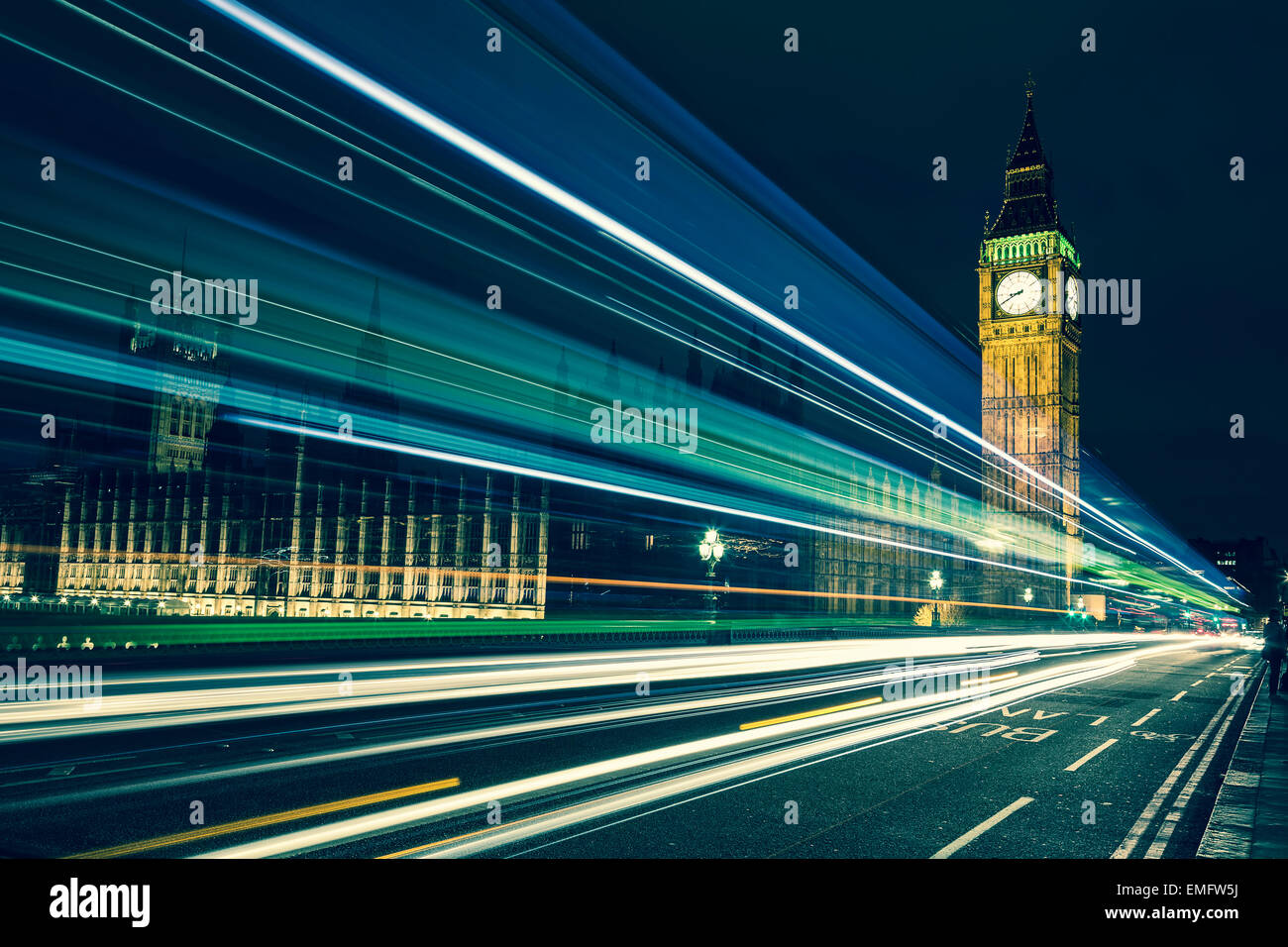 Big Ben, one of the most prominent symbols of both London and England, as shown at night along with the lights of the cars passi Stock Photo