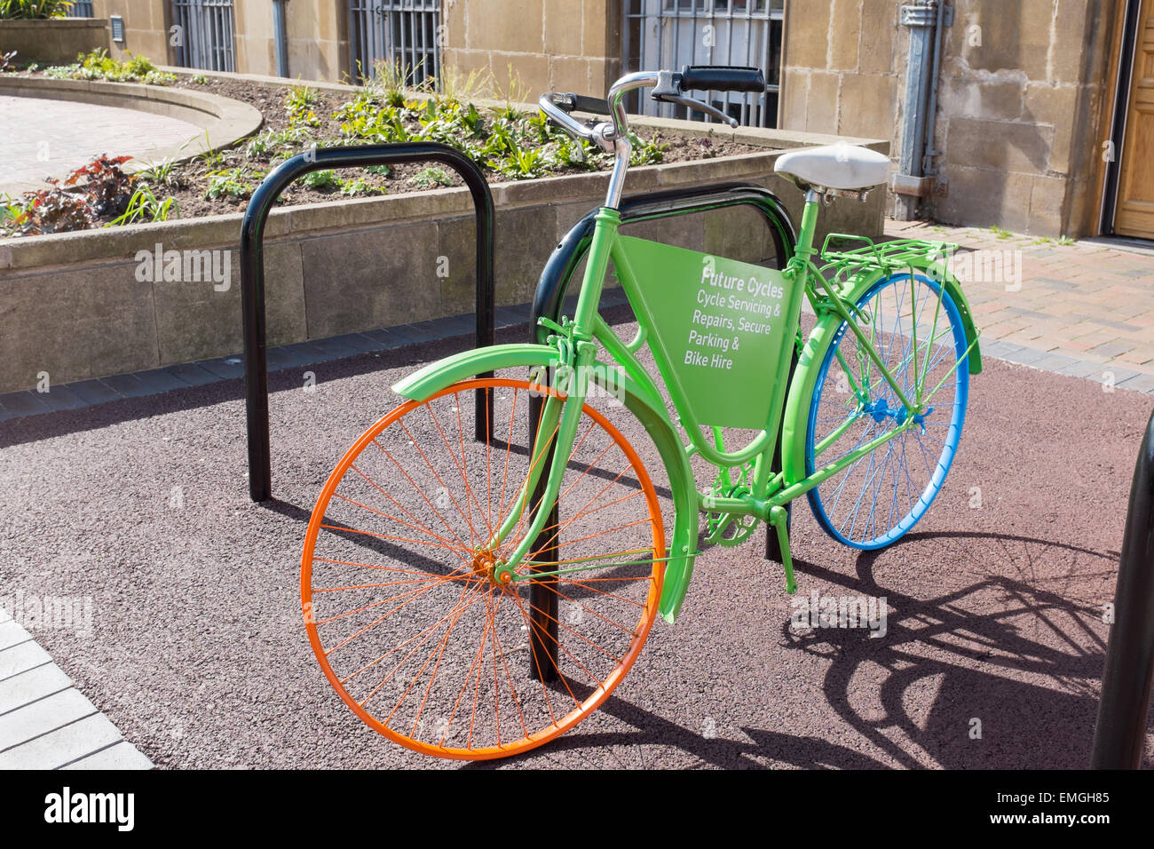 Very brightly painted bicycle advertising Future Cycles bicycle repair shop in the centre of