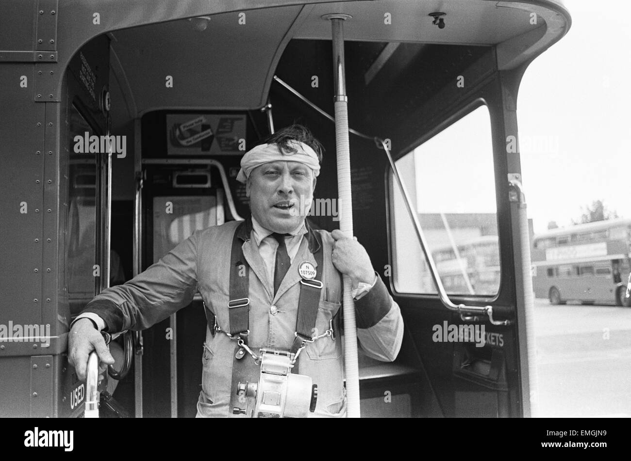 A conductor at the Hanwell bus garage of London transport wearing a mock turban to express protest at the fact that sikh Tarsen Singh Sandhu is allowed to wear his turban while driving a bus. 2nd July 1968. Stock Photo