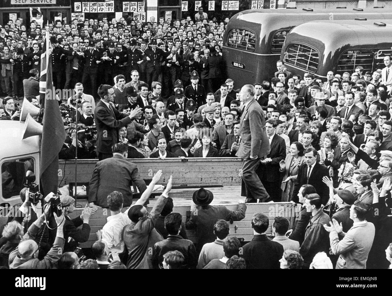 Sir Oswald Mosley prepares for his address by climbing on to the back of a lorry. He was met by a hail of missiles including rotten fruit, pennies and stones as people tried to storm the platform. His speech was drowned out by continuous chorus of 'down with the fascists'. 2nd August 1962 Stock Photo
