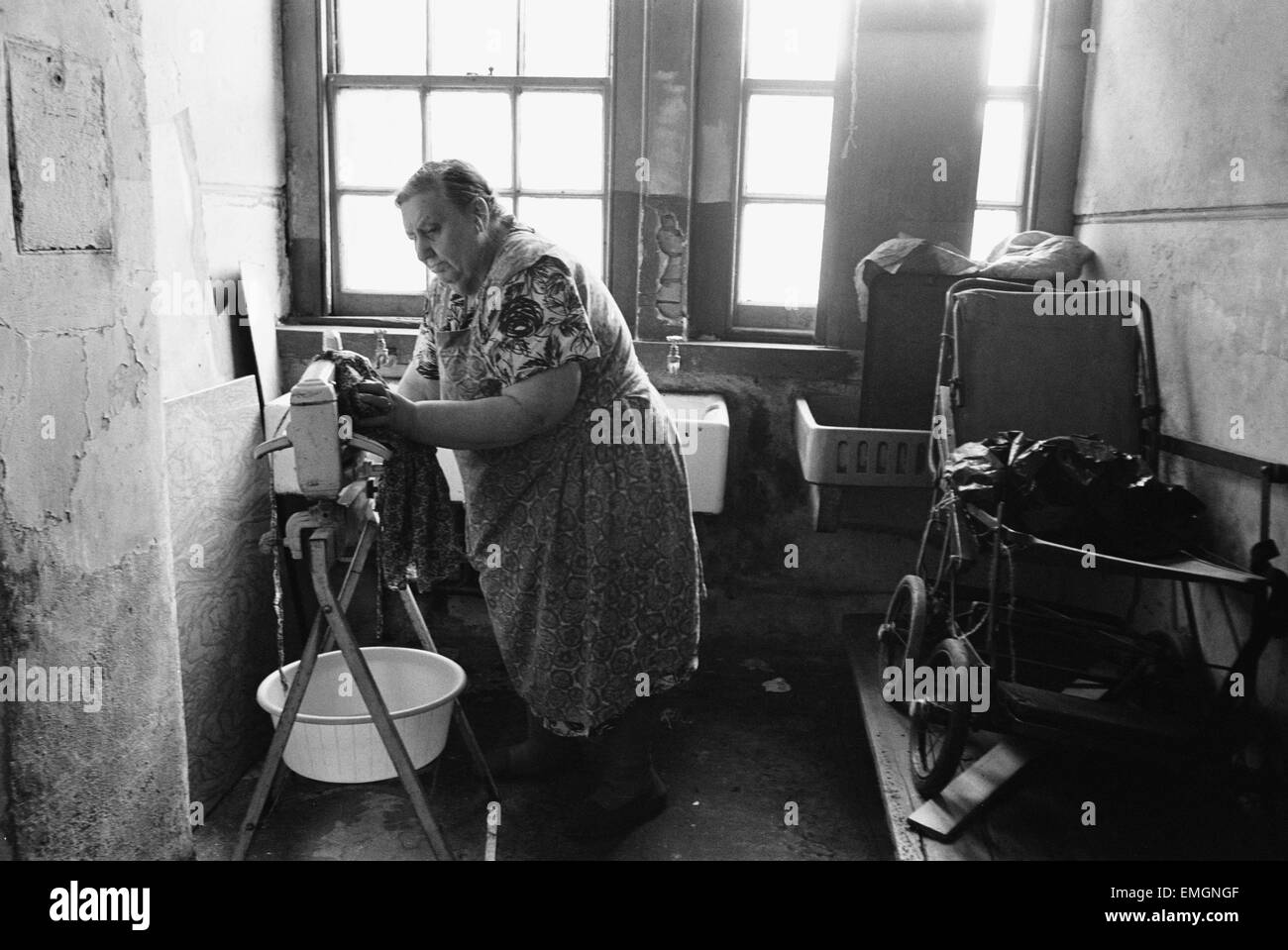 71 year old Edna Clarke does her washing in the communal wash house at Great Eastern Buildings in Stepney, East London. 11th May 1976. Stock Photo