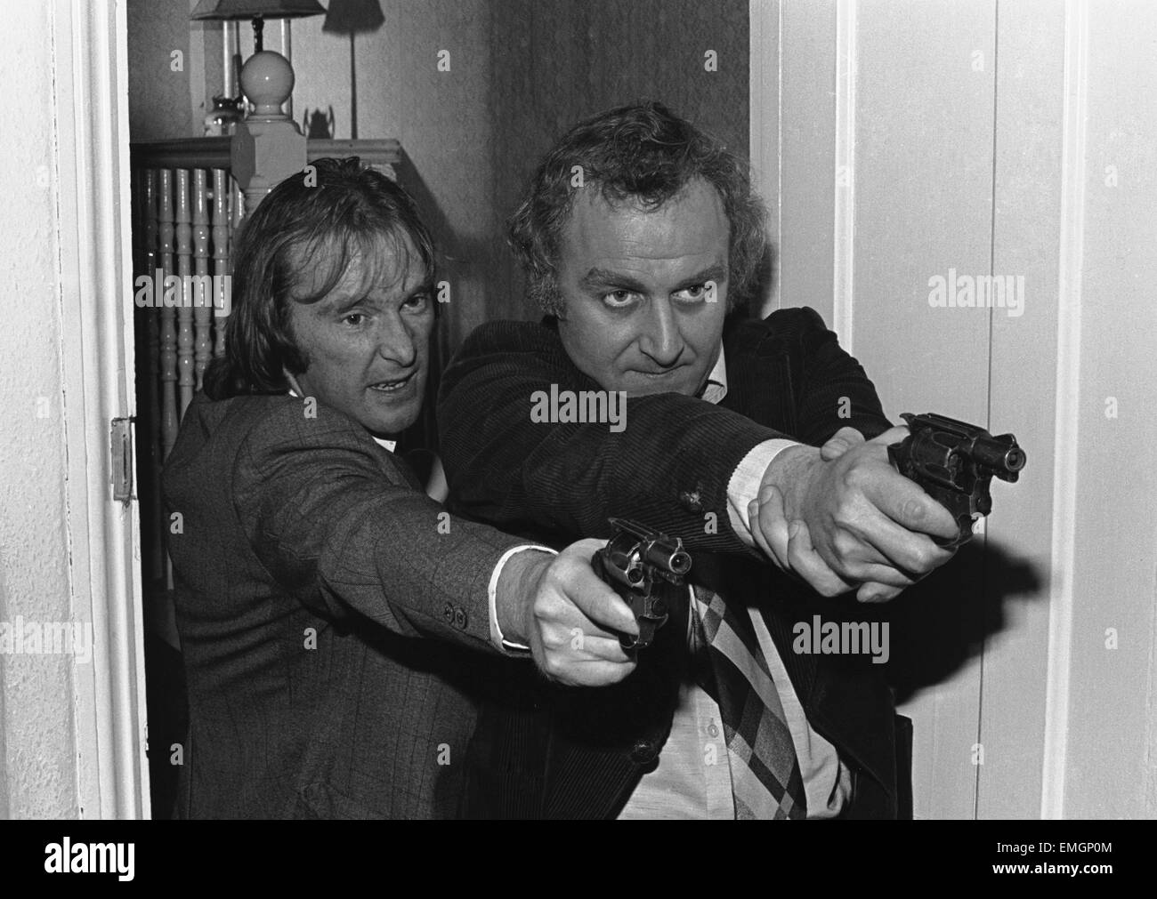 Detective Sergeant George Carter (left played by Dennis Waterman) and Detective Inspector John 'Jack' Regan (right played by John Thaw) seen here during rehearsals before a take on the set of the Euston Films TV series The Sweeney. The series focuses on the Flying Squad, a branch of the Metropolitan Police tasked with tackling armed robbery and violent crime in London. The programme's title derives from Sweeney Todd, which is Cockney rhyming slang for 'Flying Squad'. 8th December 1975 Stock Photo