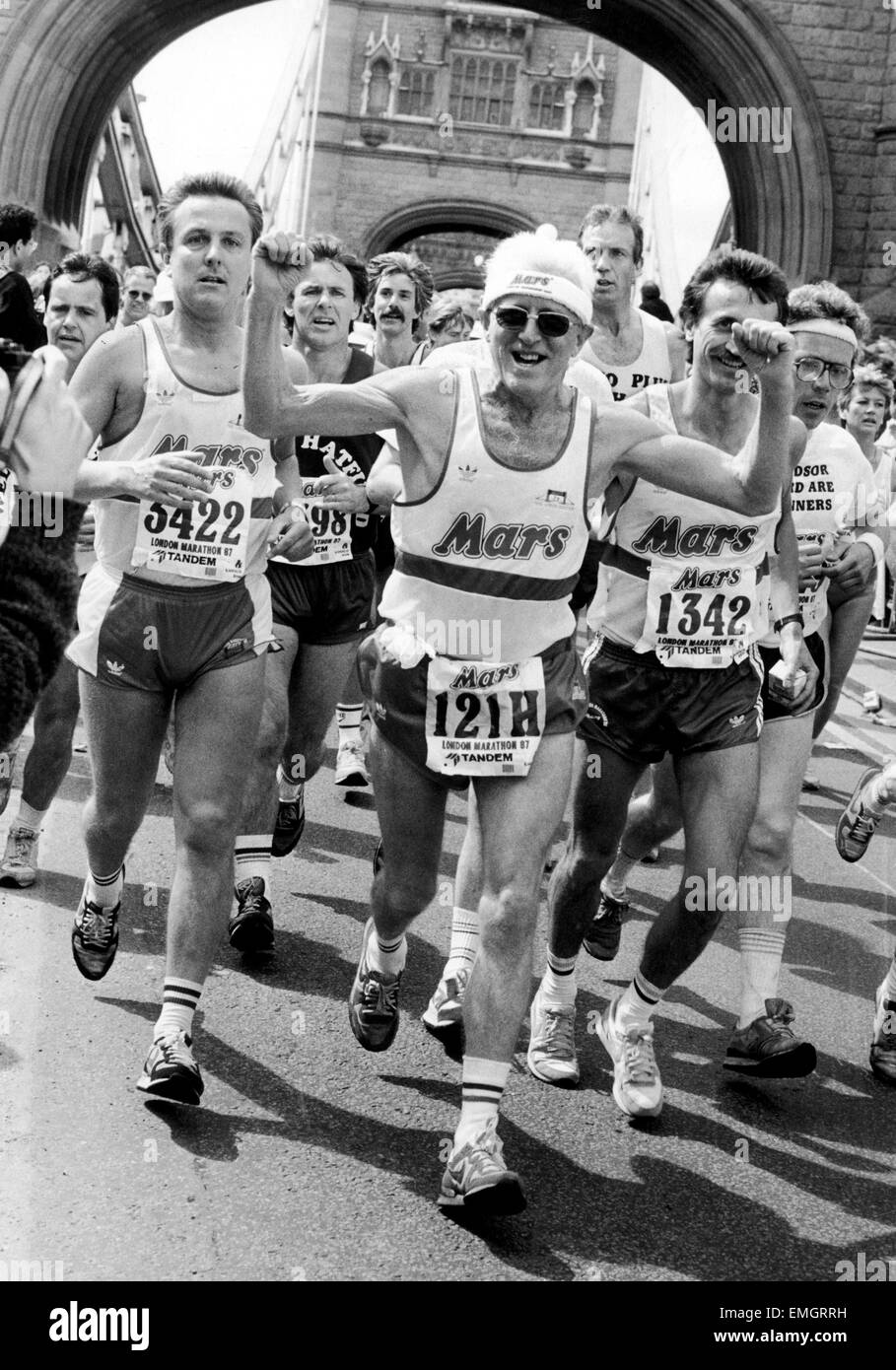 Television presenter Jimmy Saville on Tower Bridge as he participates in the London Marathon. April 1987. Stock Photo