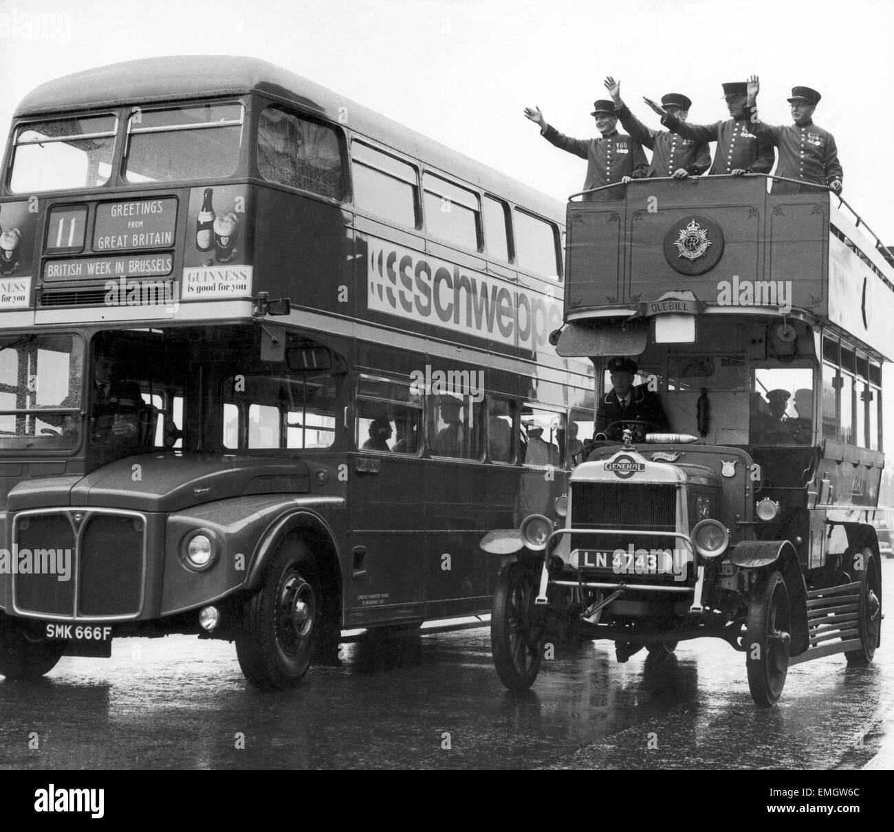 Ole Bill ,a London bus form around 1914, is overtaken by one of the modern day Routemaster buses on Waterloo Bridge. On top are four Chelsea pensioners waving off the Routemaster as it leaves Tilbury for Brussels for 'British Week'. 25th September 1967. Stock Photo