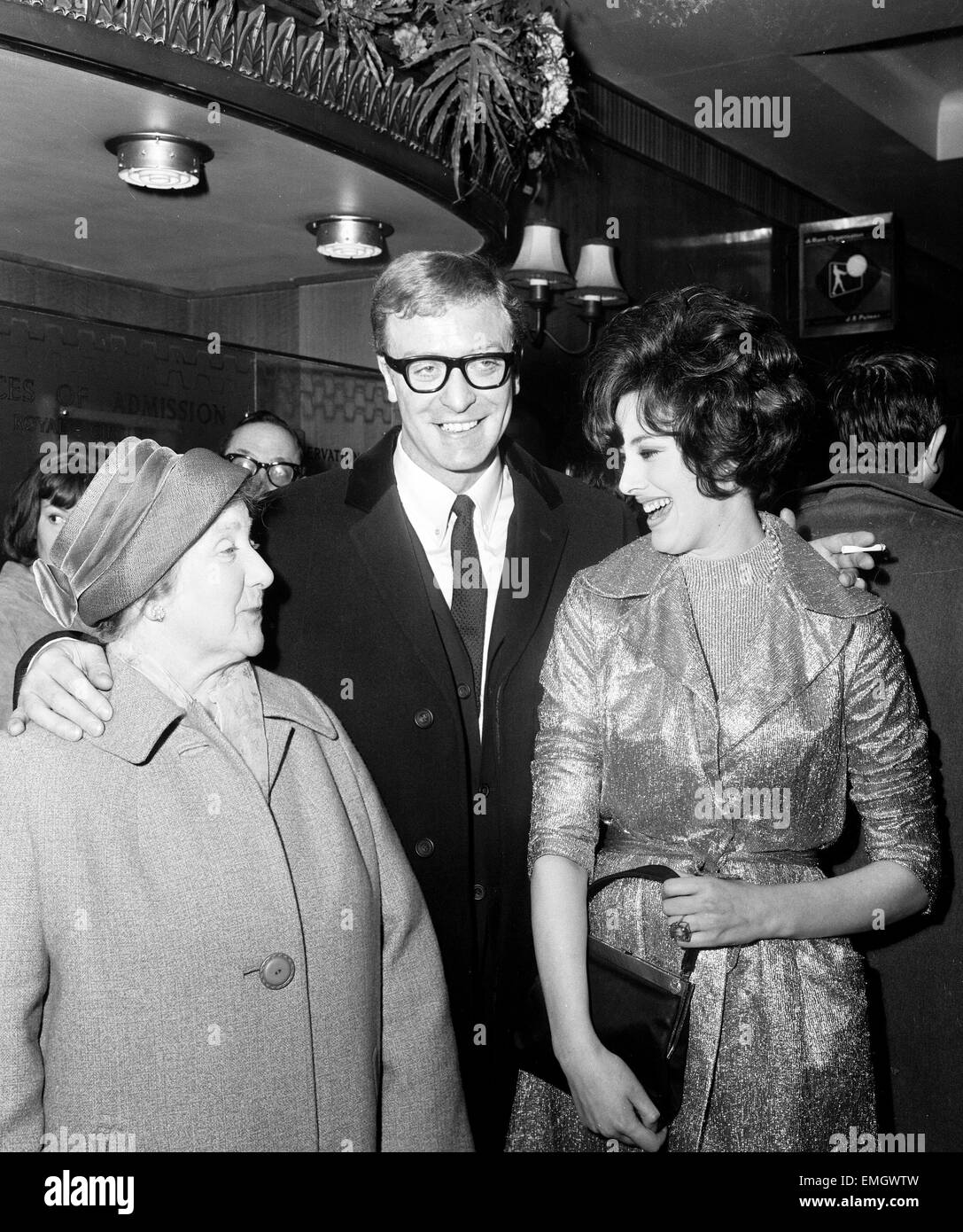 Michael Caine with his mother, Marie Micklewhite and leading lady Sue Lloyd at the Premiere of 'The Ipcress File' 19 March 1965 Stock Photo