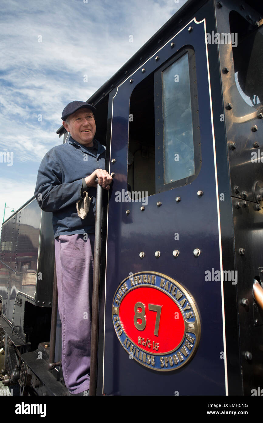 UK, Wales, Gwynedd, Porthmadog, Welsh Mountain Railway, train driver in cab Stock Photo