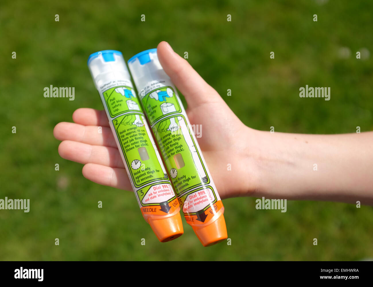 A boy using an epipen in his thigh demonstrating what to do in the