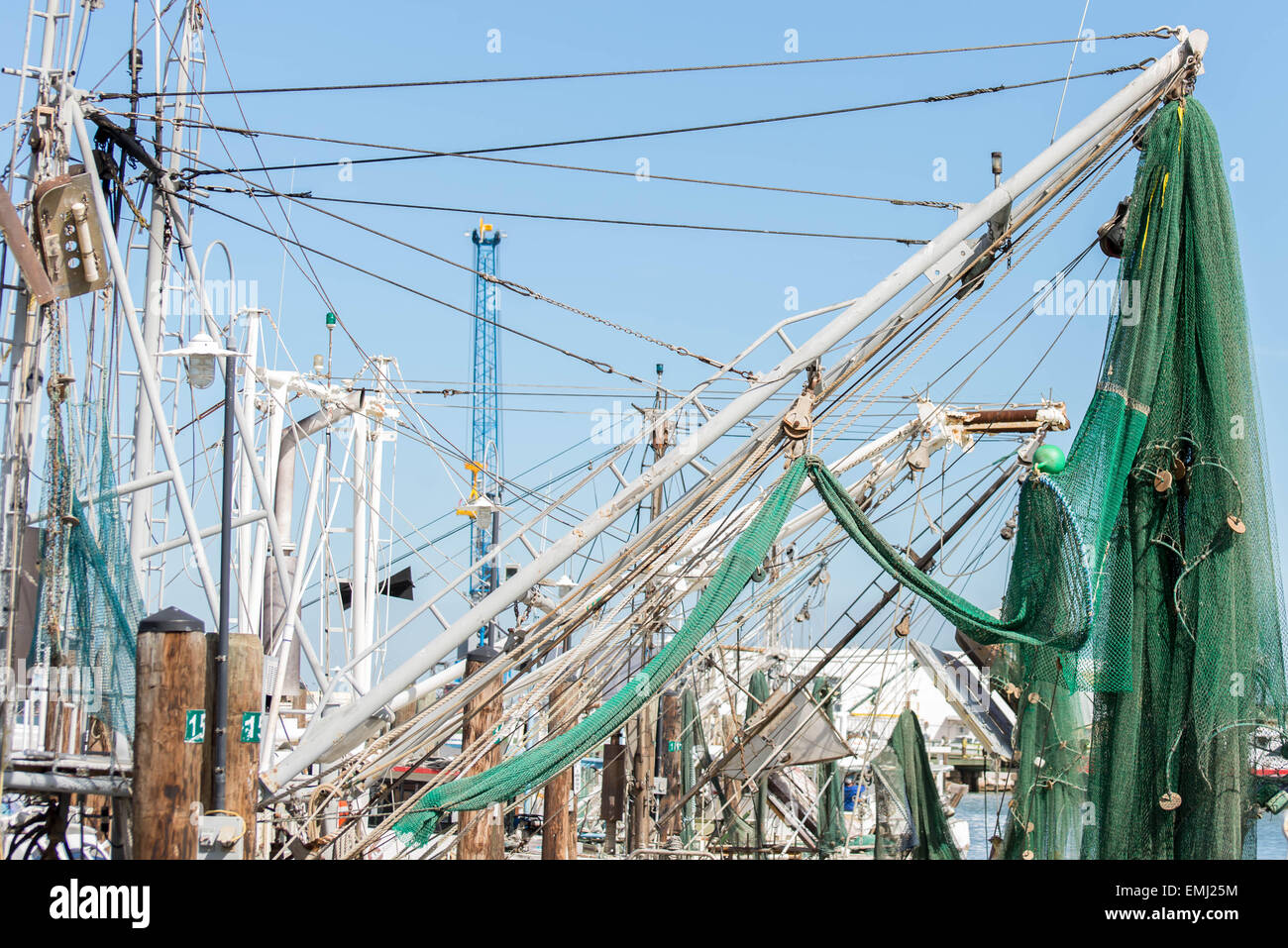 commercial fishing boats with nets at the ocean marina docks Stock