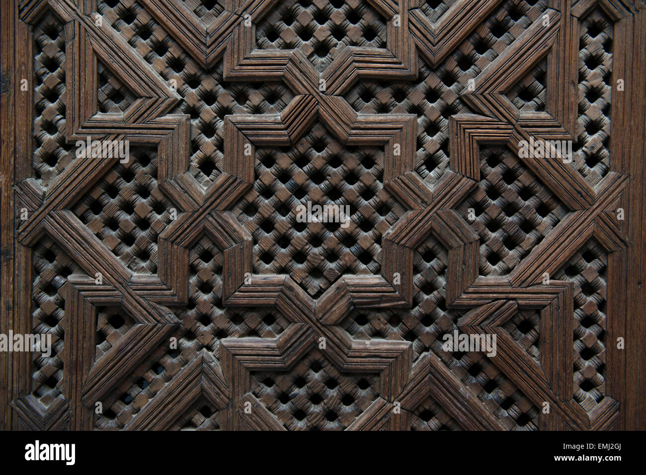 Al Attarine Madrasa, Koranic school, in Fes, Morocco.  Detail of carved cedar door. Stock Photo