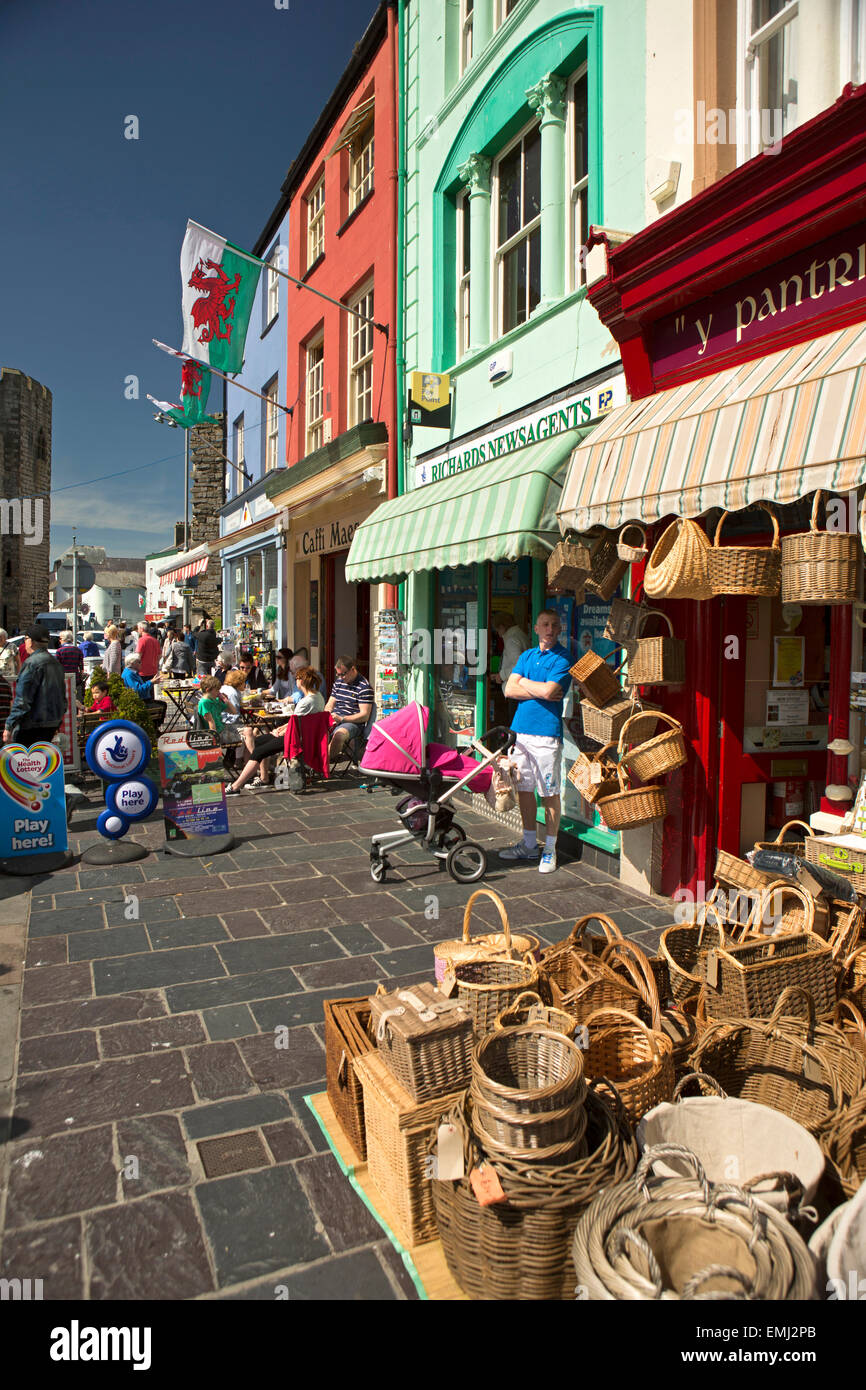 UK, Wales, Gwynedd, Caernarfon, Y Maes, colourfully painted shops with market in progress Stock