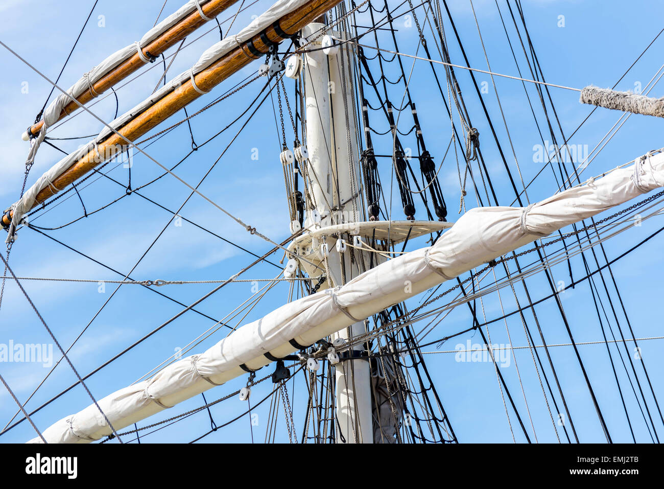 masts, rigging and rolled up sails of a tall sailboat Stock Photo Alamy
