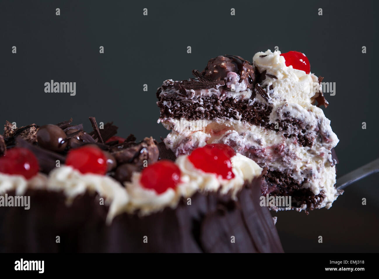 Chocolate cake with cream and cherries on top Stock Photo