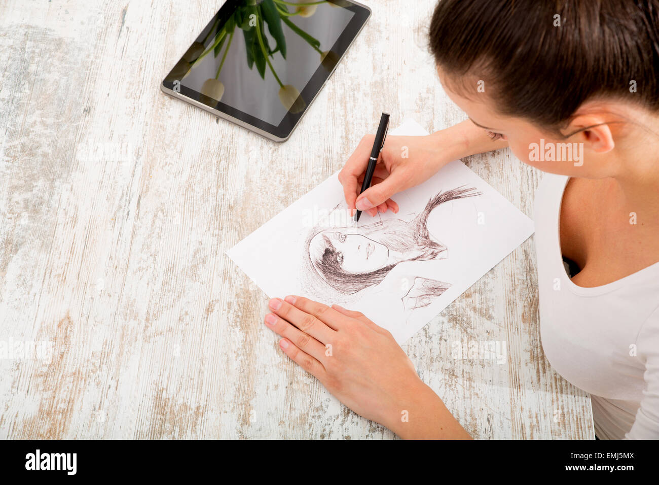 A young fashion designer working with a tablet pc Stock Photo - Alamy