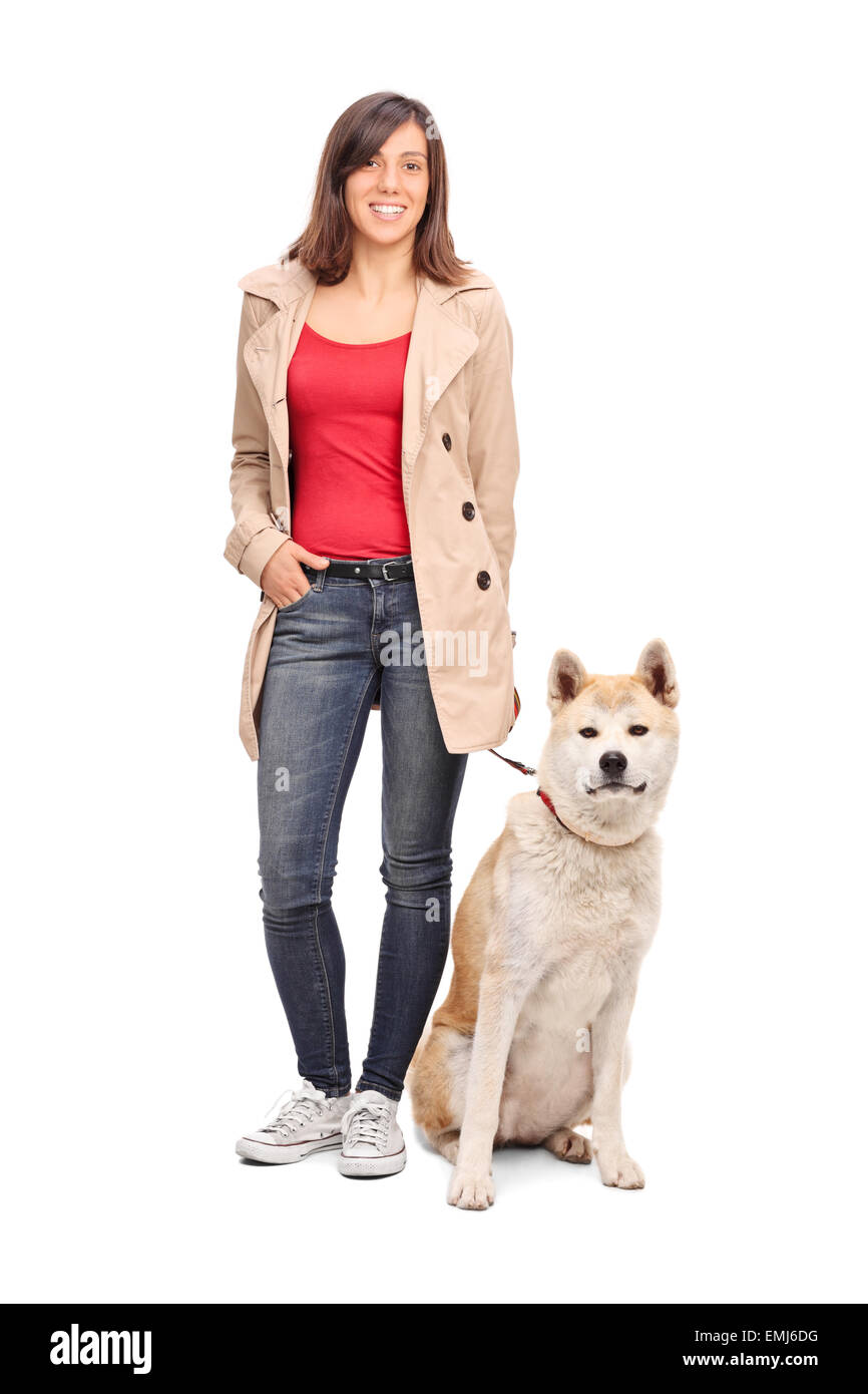 Full length portrait of a young girl posing with a Japanese Akita dog isolated on white background Stock Photo