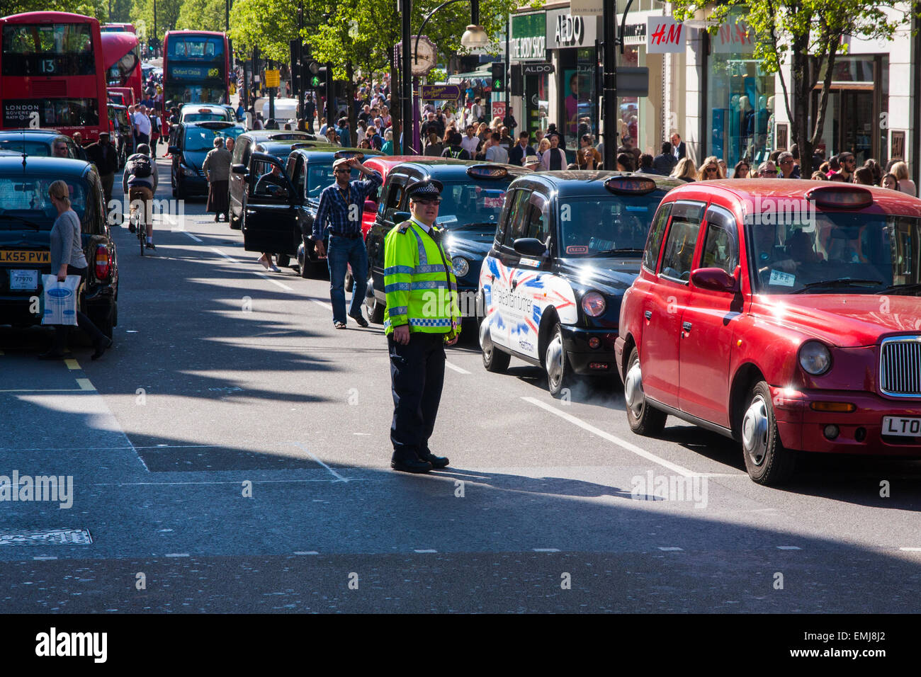 London, UK. 21st April, 2015. Hundreds of London black taxi operators bring traffic to a standstill as they protest on Oxford Street against what they say is Transport For London's failure to enforce their own regulations, allowing illegal minicabs to operate putting the public at risk and taking potential earnings from licenced operators. Credit:  Paul Davey/Alamy Live News Stock Photo