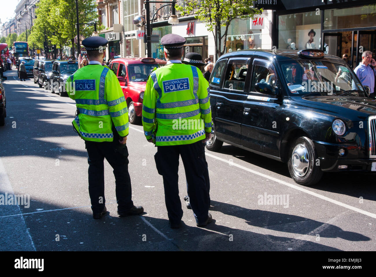 London, UK. 21st April, 2015. Hundreds of London black taxi operators bring traffic to a standstill as they protest on Oxford Street against what they say is Transport For London's failure to enforce their own regulations, allowing illegal minicabs to operate putting the public at risk and taking potential earnings from licenced operators. Credit:  Paul Davey/Alamy Live News Stock Photo