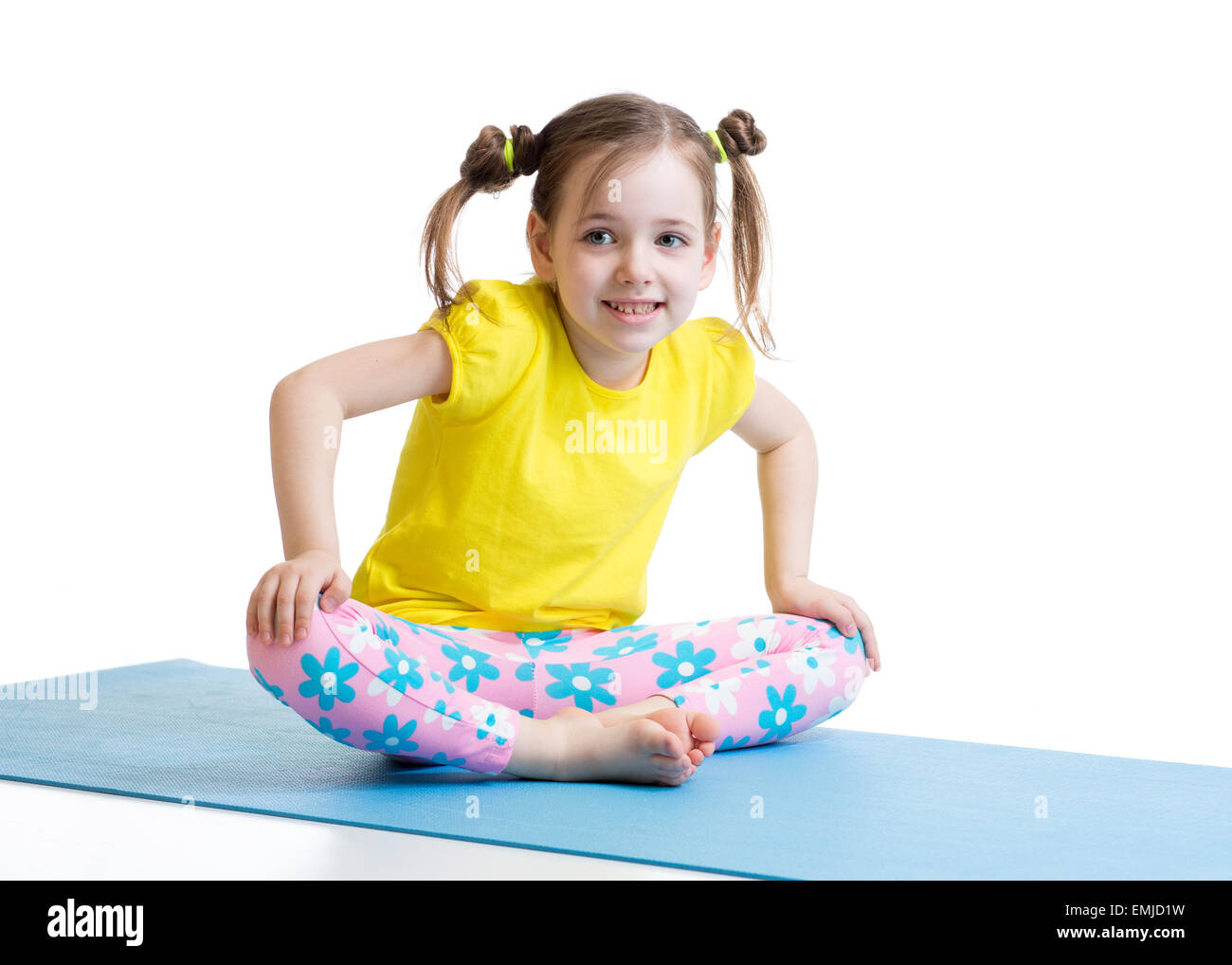 kid does gymnastics sitting in butterfly pose Stock Photo