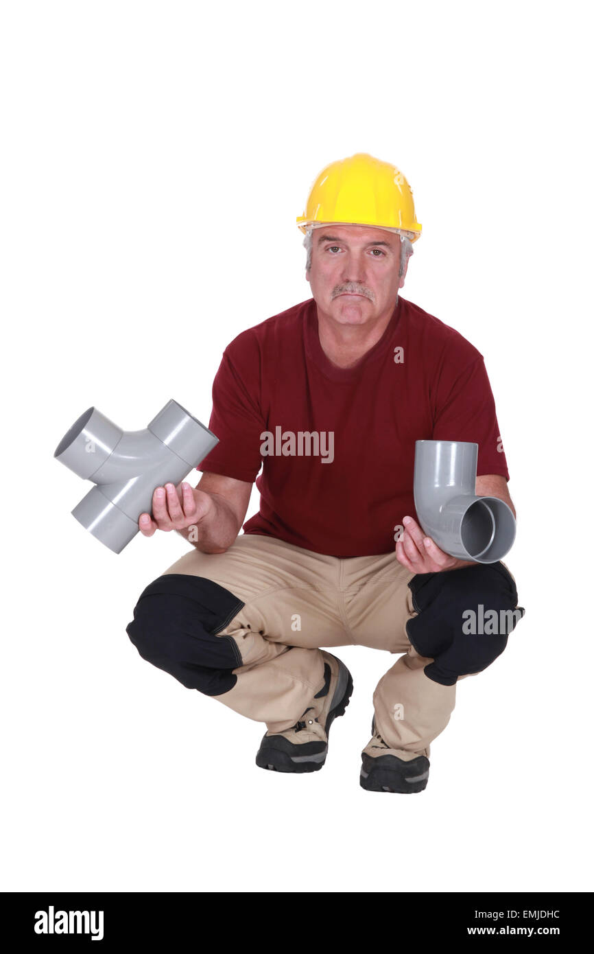 Plumber with plastic pipes Stock Photo Alamy