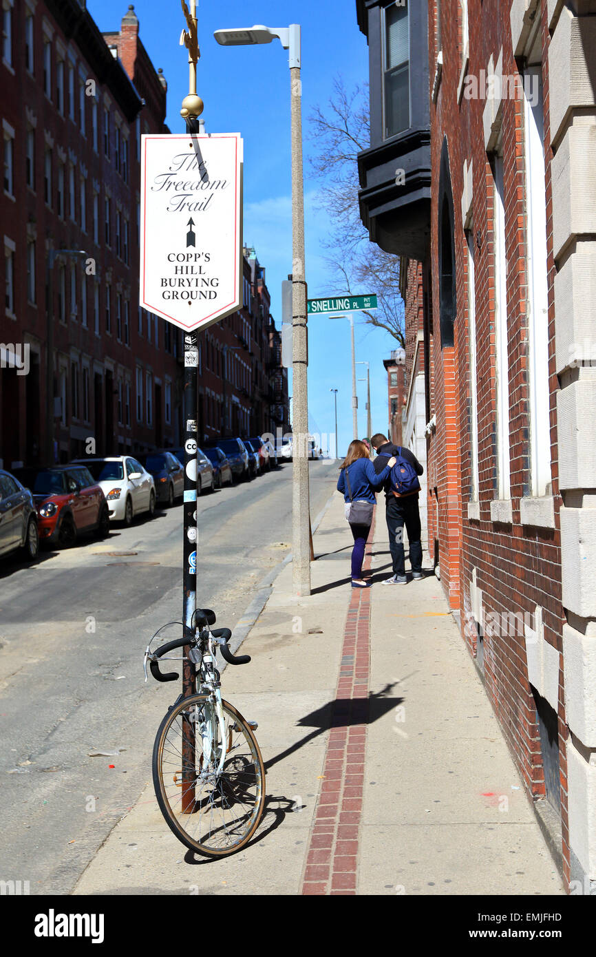 Boston Freedom Trail sign with tourists walking to Copp's Hill Burying Ground landmark. Boston Massachusetts. Stock Photo