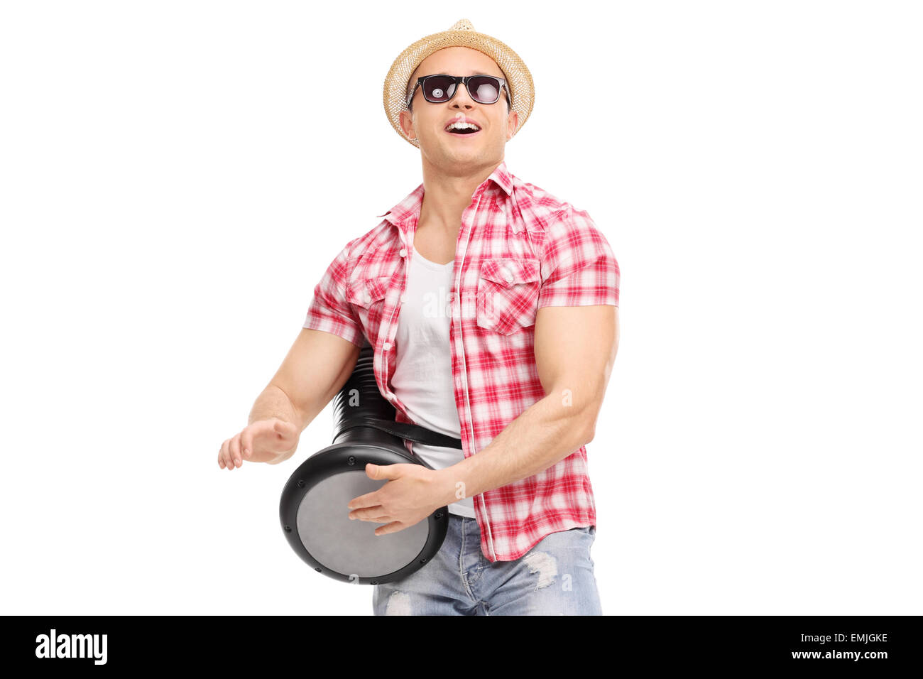 Young joyful man playing on a doumbek and dancing isolated on white
