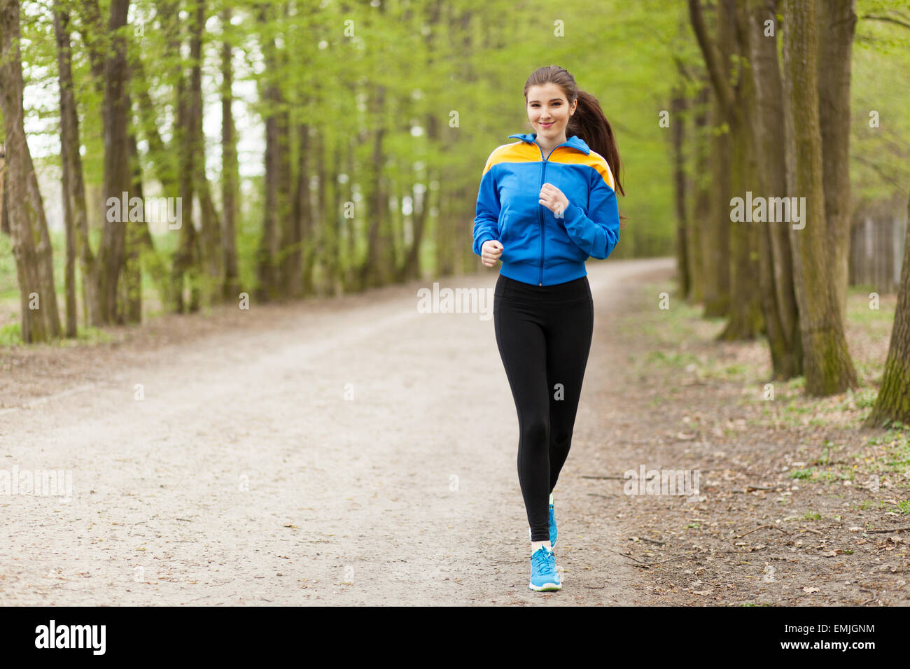Young beautiful woman running on a trail Stock Photo - Alamy