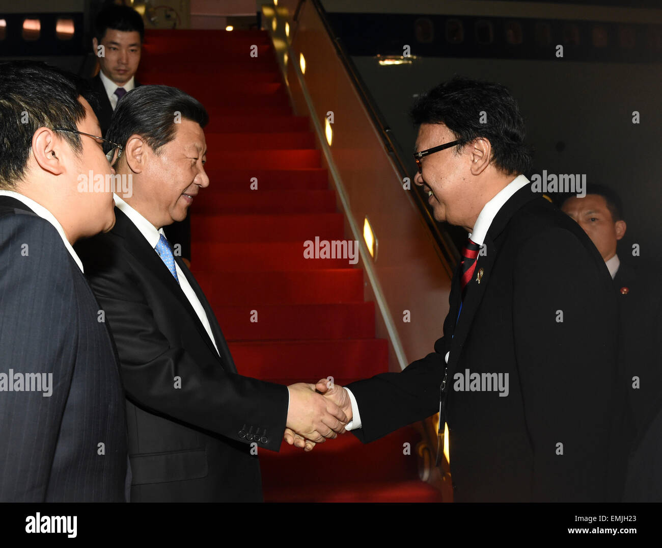 Jakarta, Indonesia. 21st Apr, 2015. Chinese President Xi Jinping (2nd L, front) is welcomed upon his arrival in Jakarta, capital of Indonesia, April 21, 2015. Xi Jinping arrived in Indonesia late Tuesday for an Asian-African summit and commemorative activities for the historic 1955 Bandung Conference. © Li Xueren/Xinhua/Alamy Live News Stock Photo