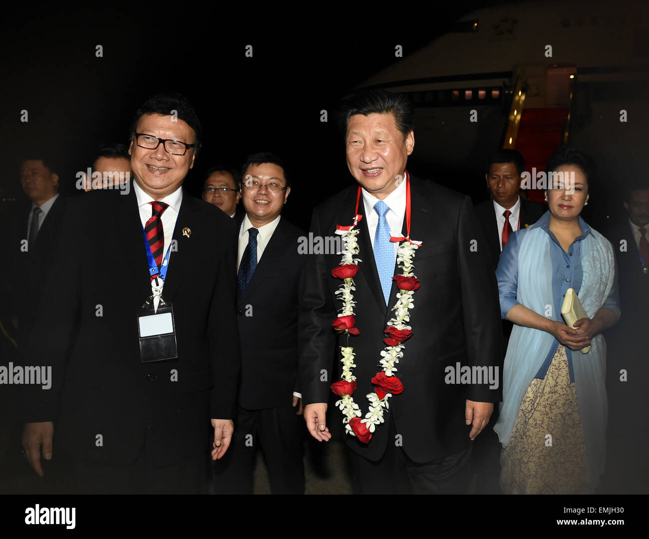 Jakarta, Indonesia. 21st Apr, 2015. Chinese President Xi Jinping and his wife Peng Liyuan are welcomed upon their arrival in Jakarta, capital of Indonesia, April 21, 2015. Xi Jinping arrived in Indonesia late Tuesday for an Asian-African summit and commemorative activities for the historic 1955 Bandung Conference. © Li Xueren/Xinhua/Alamy Live News Stock Photo