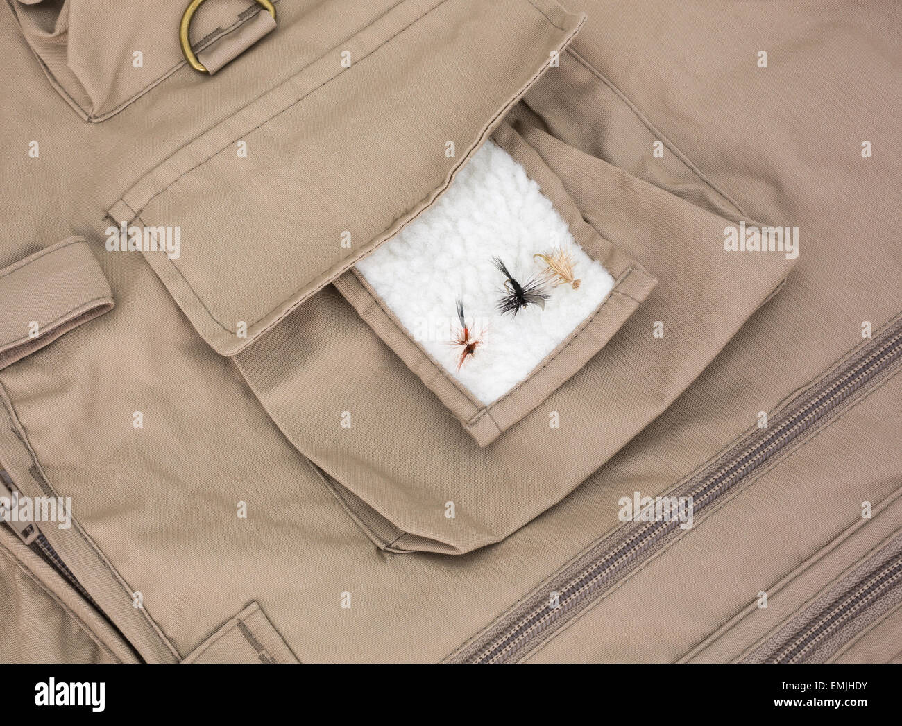 Three very small fly fishing flies on the fleece patch of a fishing vest  Stock Photo - Alamy