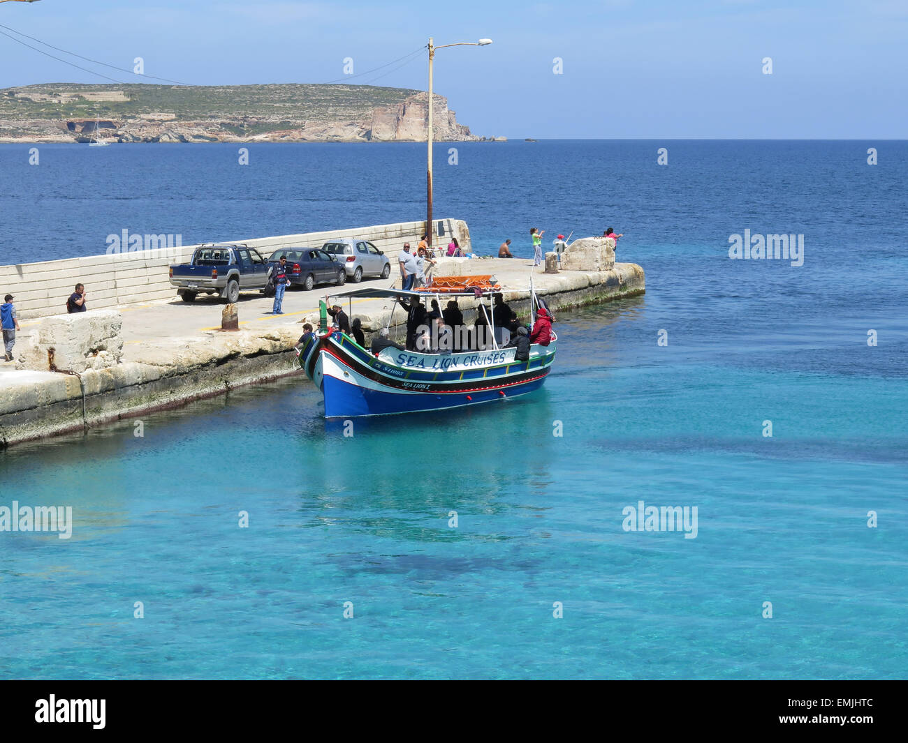 Boat ferry from Malta to Comino arriving at the Pier Stock Photo Alamy