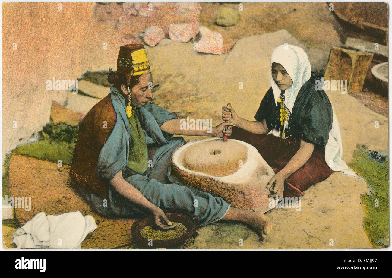 Two Women Grinding at a Mill, Jerusalem, Hand-Colored Postcard, 1914 Stock Photo