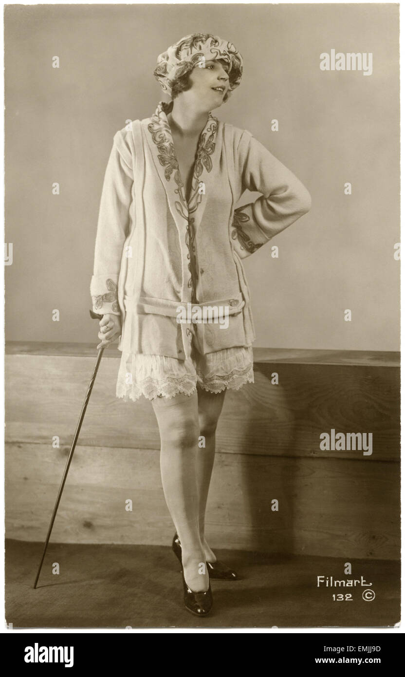 Portrait of Fashionable Woman in Short Skirt and Leaning on Cane, French Postcard, circa 1930 Stock Photo