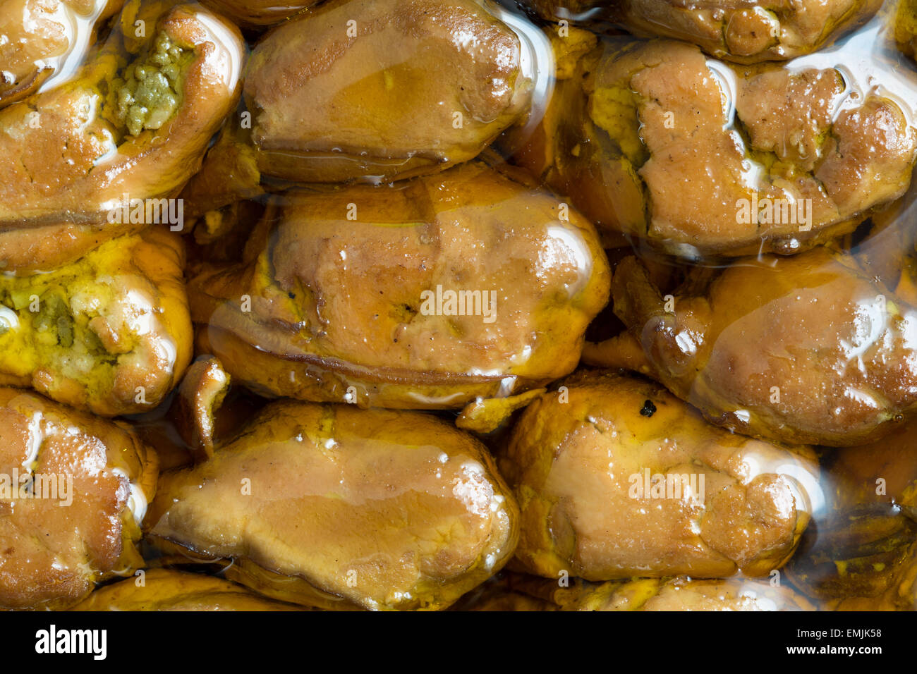 A very close view of smoked whole oysters in cottonseed oil. Stock Photo