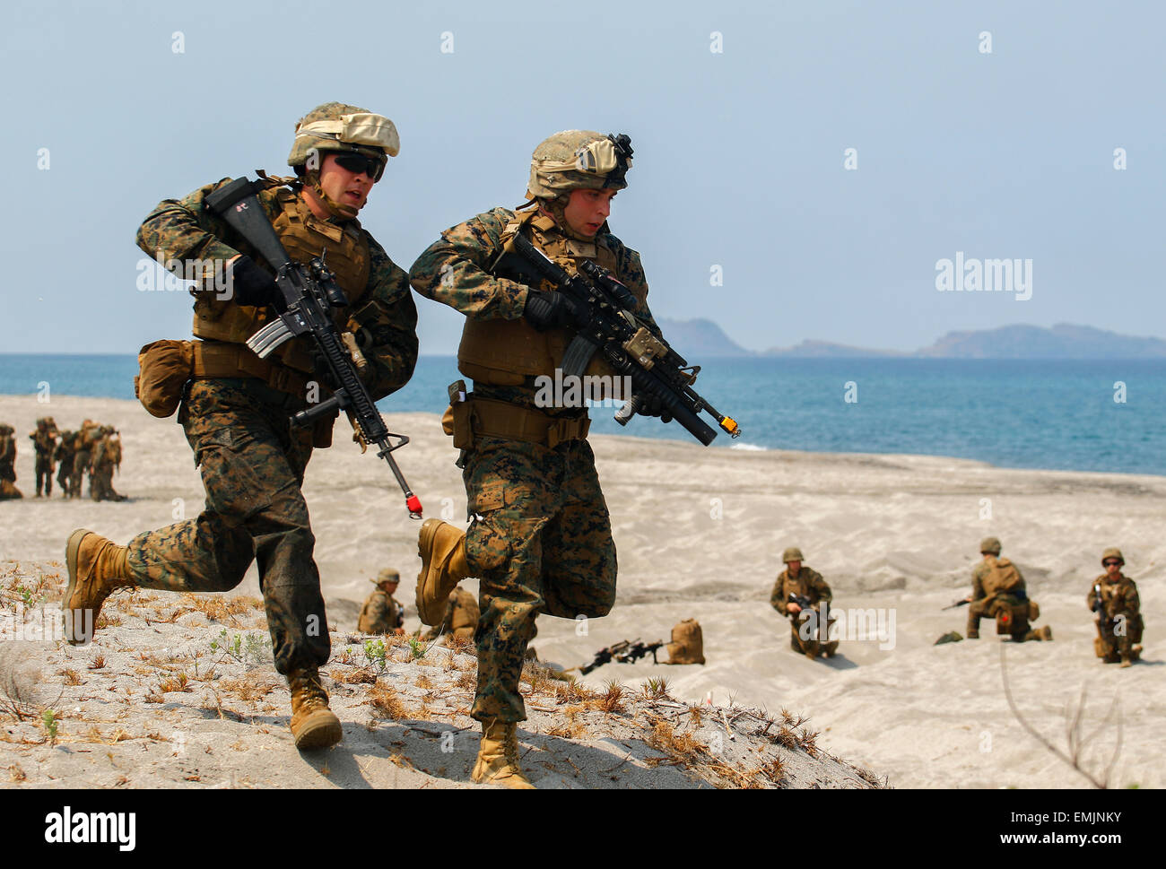 US Marines run down a beach during joint amphibious landing with Philippine and U.S. forces on North Beach at the Naval Education Training Center April 21, 2015 in Zambales, Philippines. The beach assault is part of exercise Balikatan 2015. Stock Photo