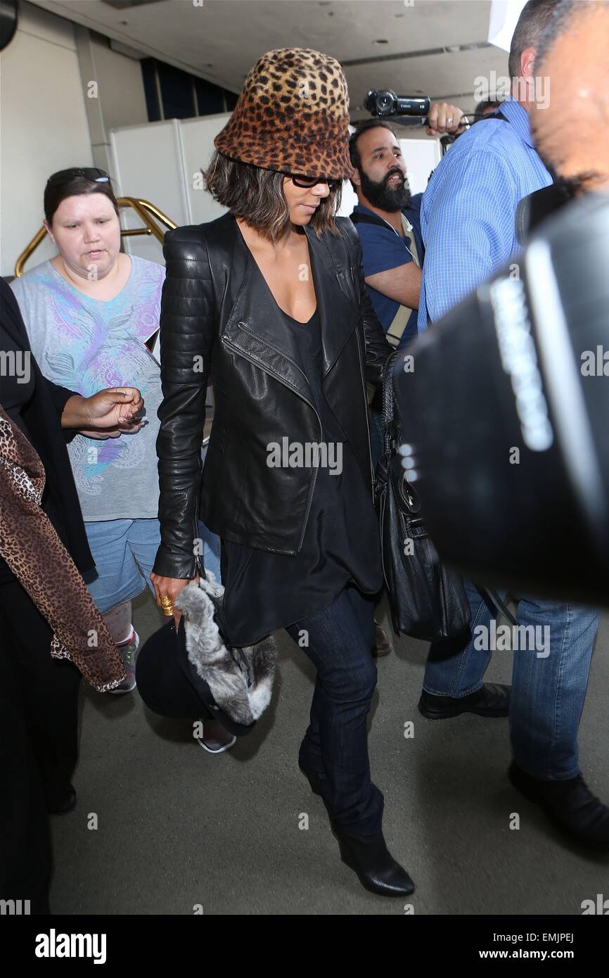 A camera shy Halle Berry conceals her face with a leopard print hat as she arrives at Los Angeles International Airport (LAX)  Featuring: Halle Berry Where: Los Angeles, California, United States When: 17 Oct 2014 Stock Photo