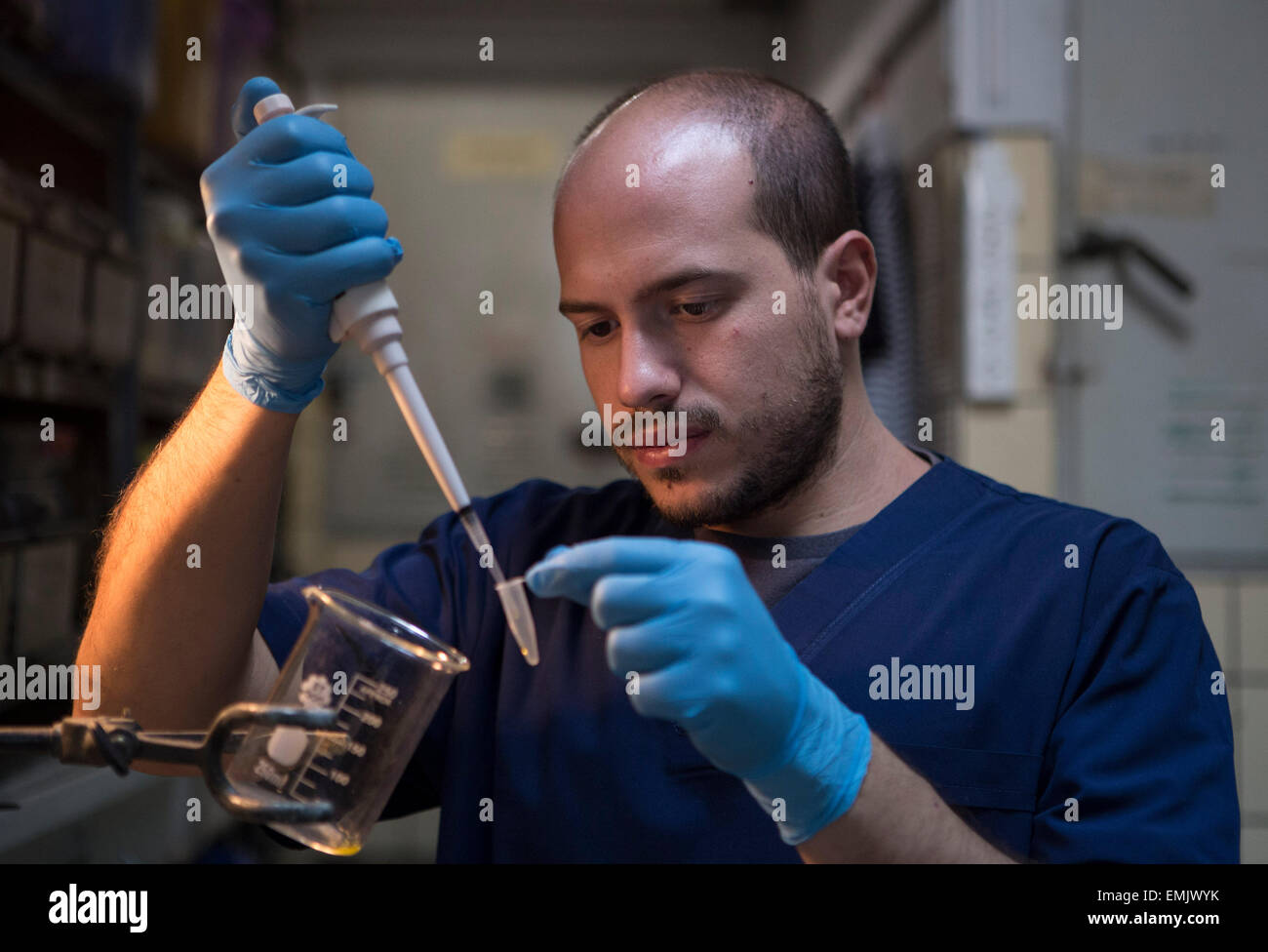 Buenos Aires, Argentina. 21st Apr, 2015. Emiliano Lertora, a biologist in the Poisonous Animals Area of the Antidotes Production Department of Malbran Institute, drops the venom from a 'Yarara' snake into a container in Buenos Aires, Argentina, on April 21, 2015. The Department is in charge of producing antidotes with the poison extracted from snakes, spiders and scorpions. © Martin Zabala/Xinhua/Alamy Live News Stock Photo