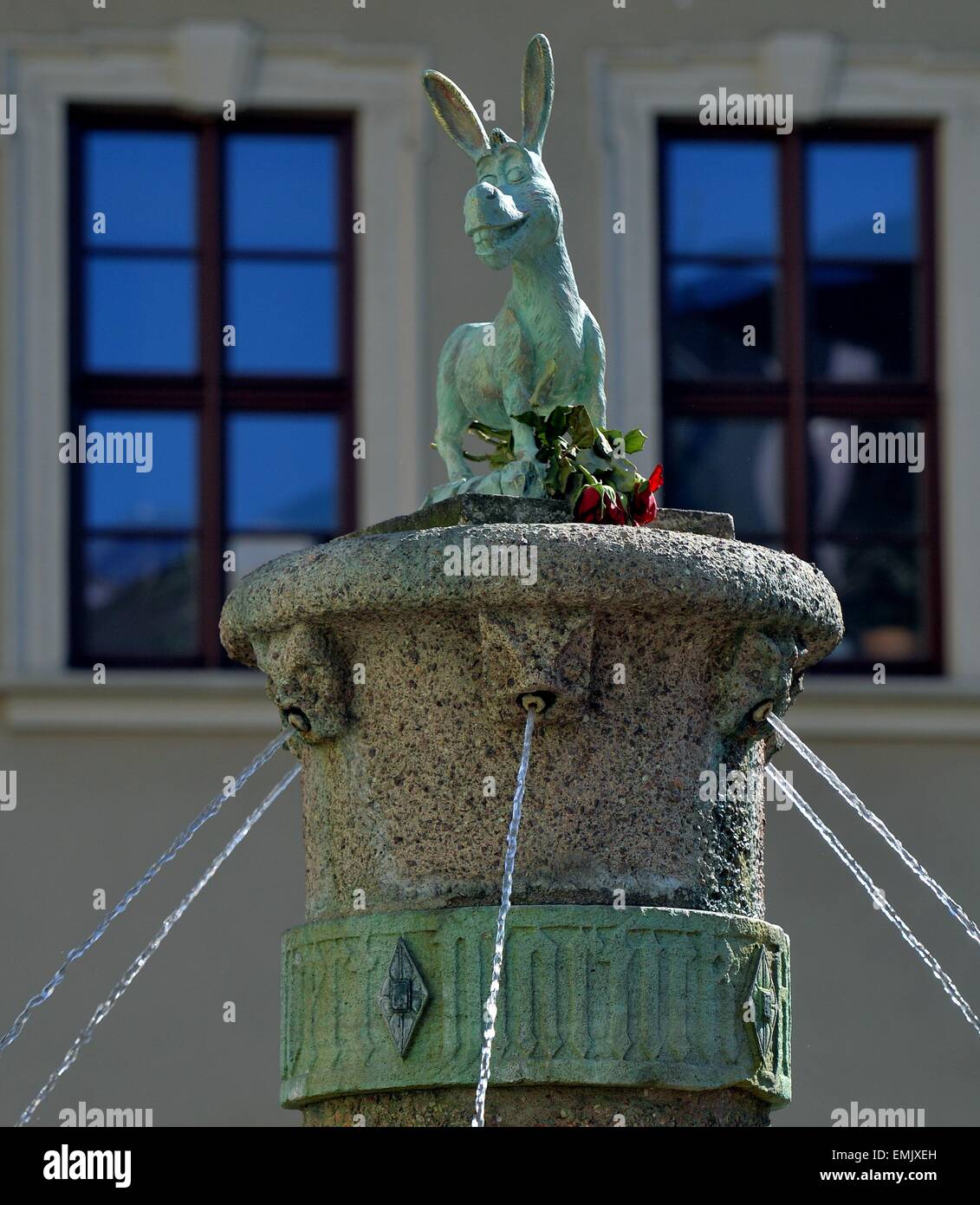 Halle, Germany. 21st Apr, 2015. A donkey sculpture which looks very much alike the character from the movie 'Shrek' decorates the Eselsbrunnen (lit. donkey fountain) on the 'Alte Markt' market square in Halle, Germany, 21 April 2015. The original sculpture on the fountain was taken off for restoration purposes. An unknown person, however, took the liberty of a joke placing the donkey from the movie Shrek on the vacant position on the fountain. PHOTO: HENRIK SCHMIDT/dpa/Alamy Live News Stock Photo