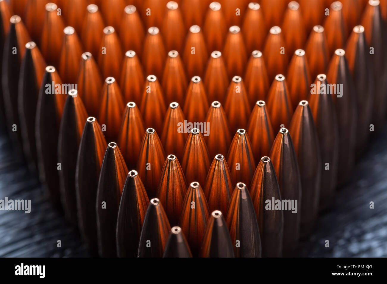 Macro shot of copper bullets that are in many rows to form a tri Stock