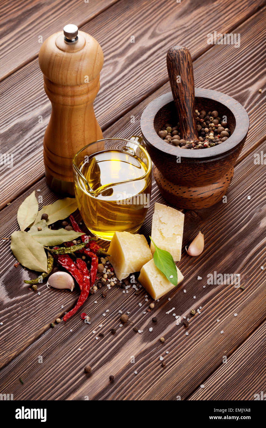 Various spices and condiments on wooden background Stock Photo
