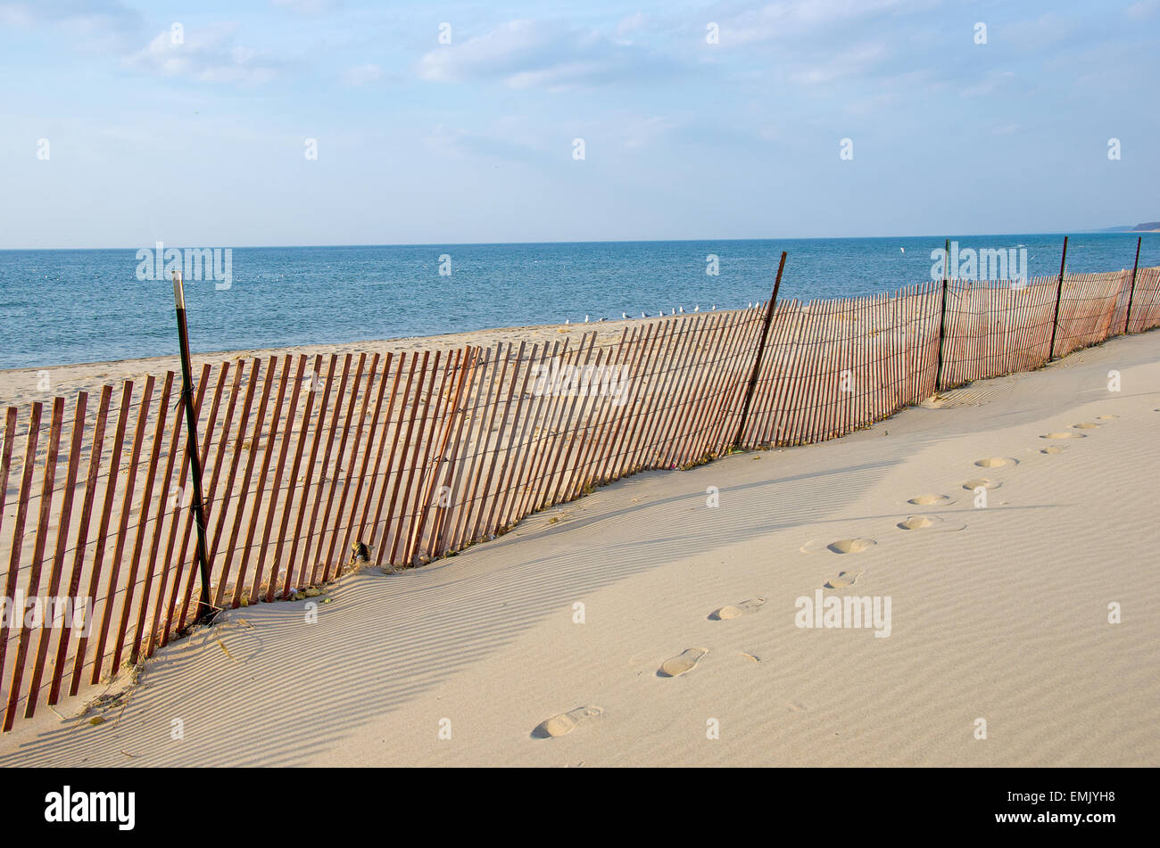 Wooden snow fence on Lake Michigan beach. Stock Photo