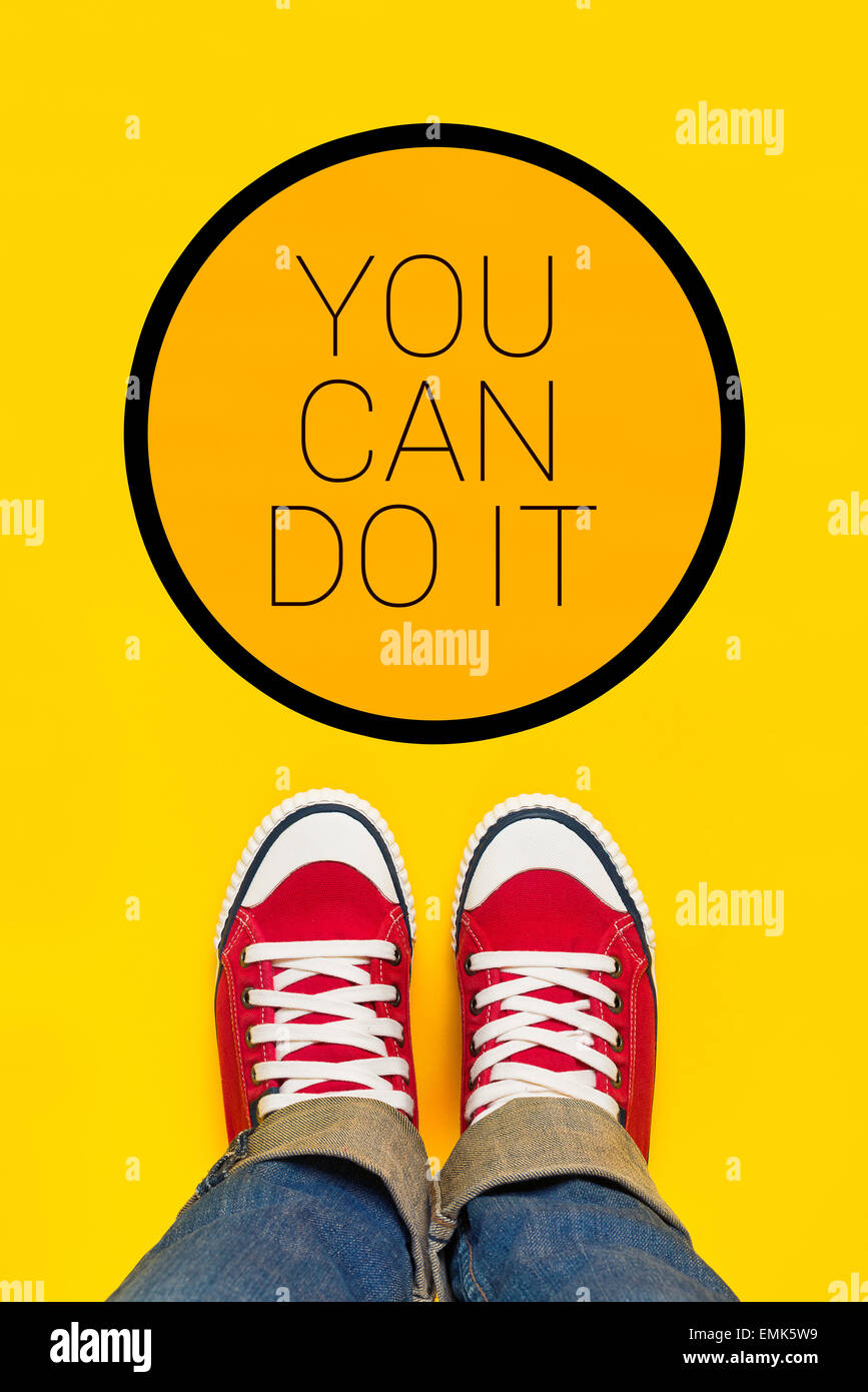 You Can Do It Motivational Message, Teenage Person in Red Sneakers Standing in Front of Inspirational Sign, Top View Stock Photo