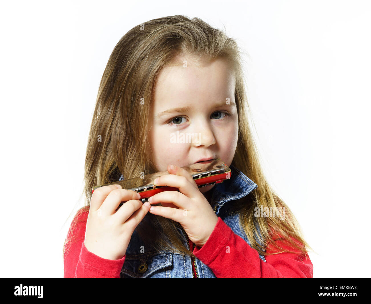 Cute little girl playing harmonica, isolated on white, music education