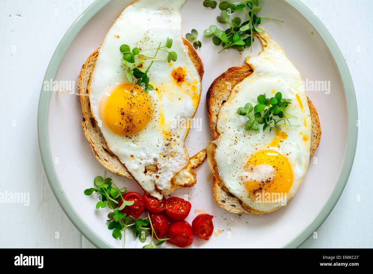 Breakfast, eggs on toast with cherry tomatoes and cress Stock Photo Alamy