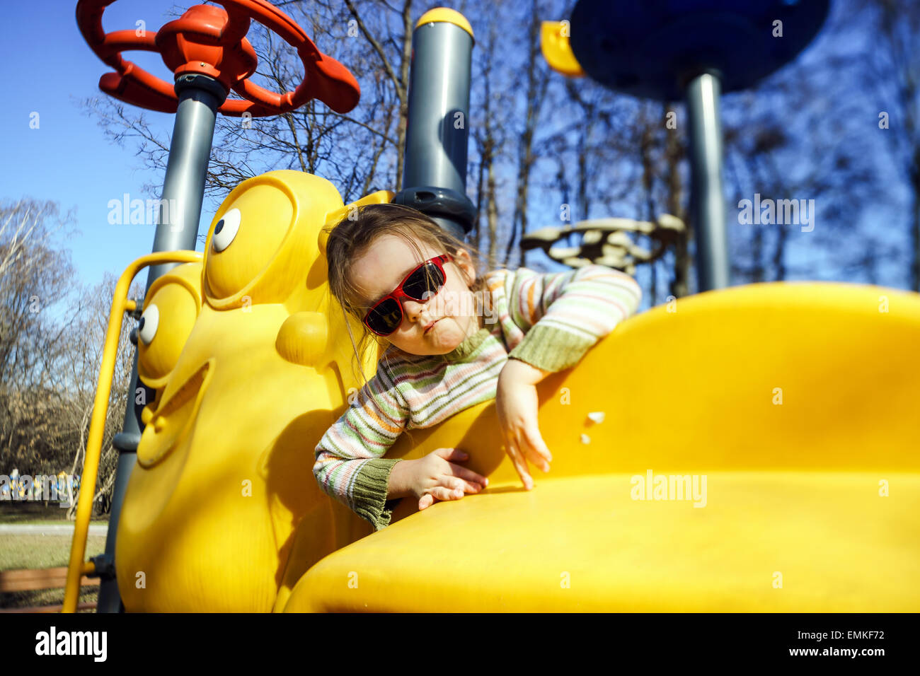 Cute little girl playing on child playground, spring sunny day Stock ...