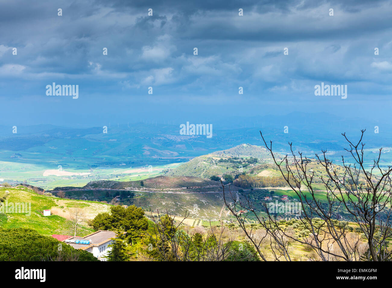dark blue rainy clouds over green sicilian hills in spring, Aidone, Italy Stock Photo