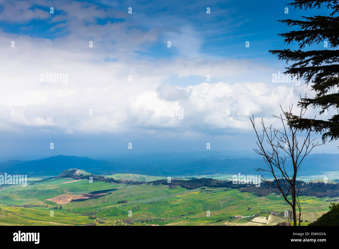 dark blue clouds over green sicilian lands in spring, Aidone, Italy Stock Photo