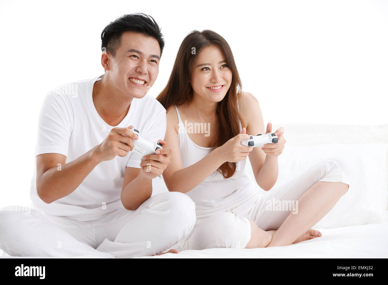 The joy of the young lovers playing games on the bed Stock Photo Alamy