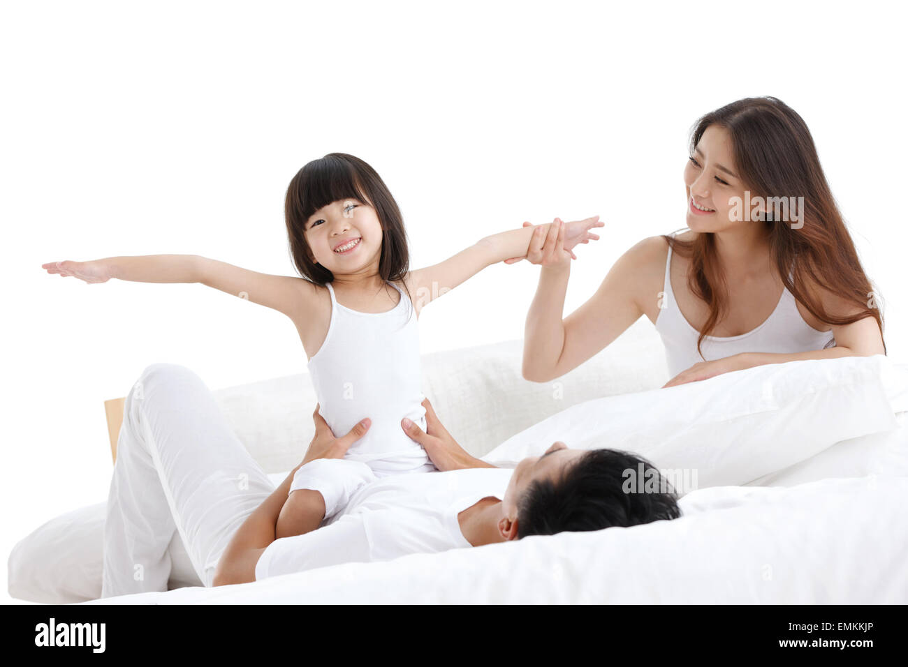 The happiness of a family of three in the bed of the bedroom to play Stock Photo